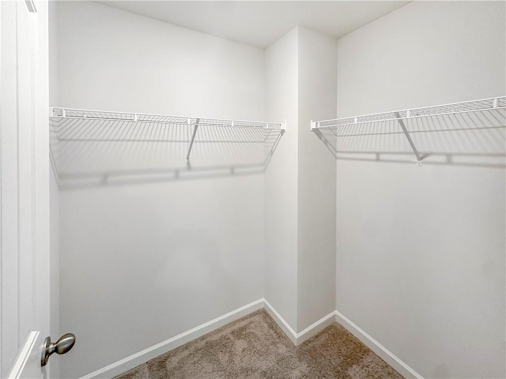 965 Athena Bend Fairburn, GA 30213 - Photo 20 of 37 a view of a room with racks on the wall