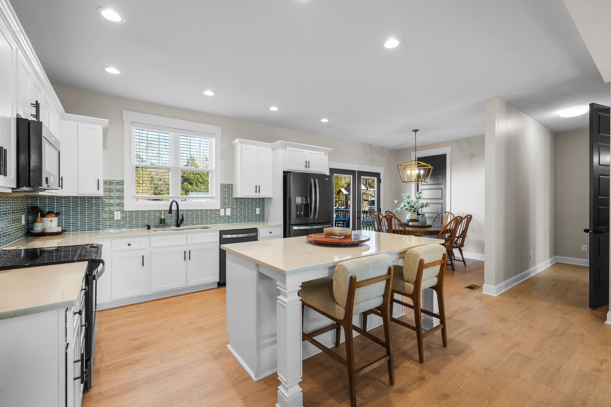1677 Mc Bride Road Lewisburg, TN 37091 - Photo 11 of 35 a kitchen with stainless steel appliances kitchen island granite countertop a table chairs sink and cabinets
