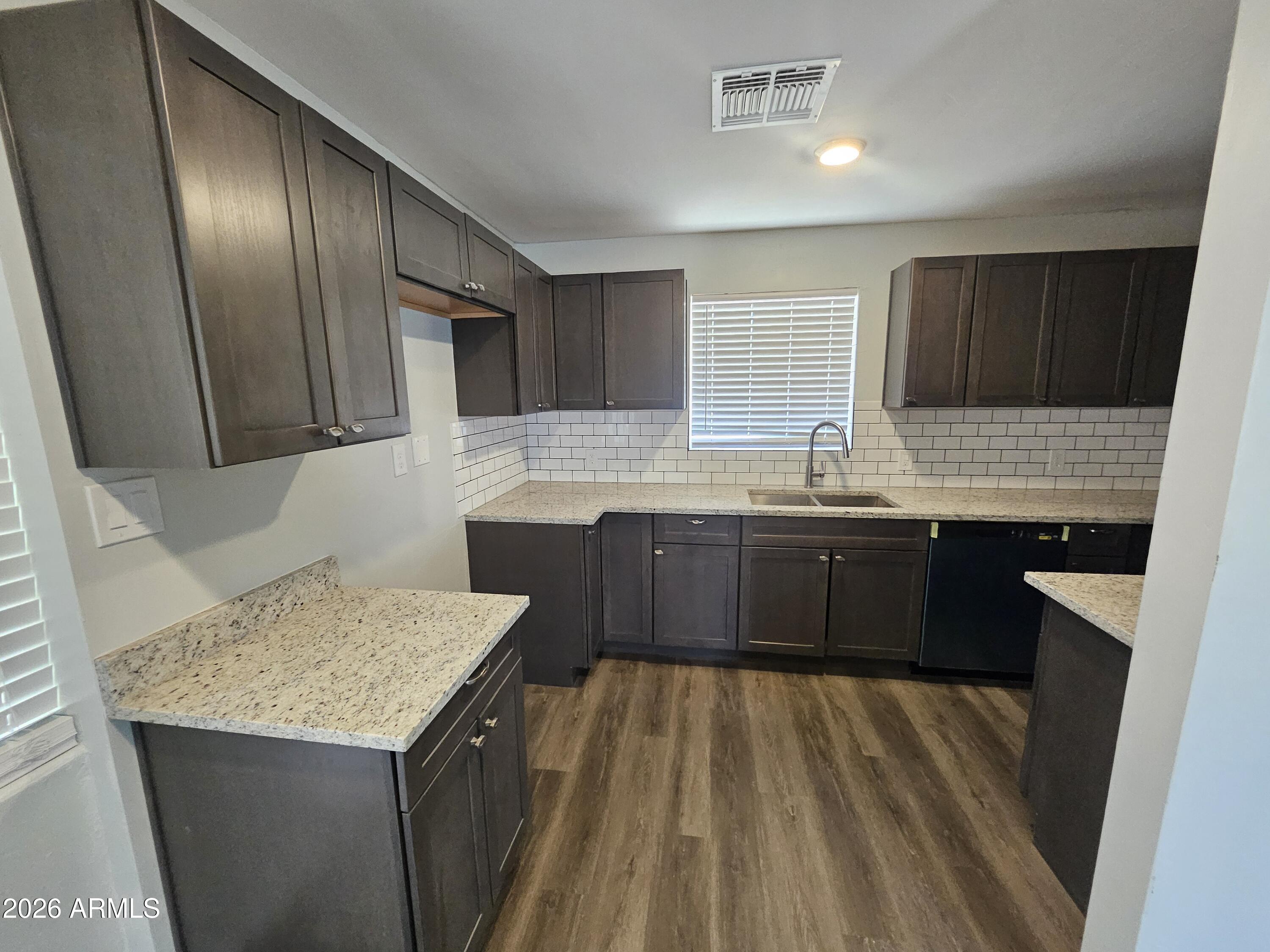 524 West 3rd Place Mesa, AZ 85201 - Photo 4 of 23 a kitchen with stainless steel appliances granite countertop wooden cabinets a sink and dishwasher