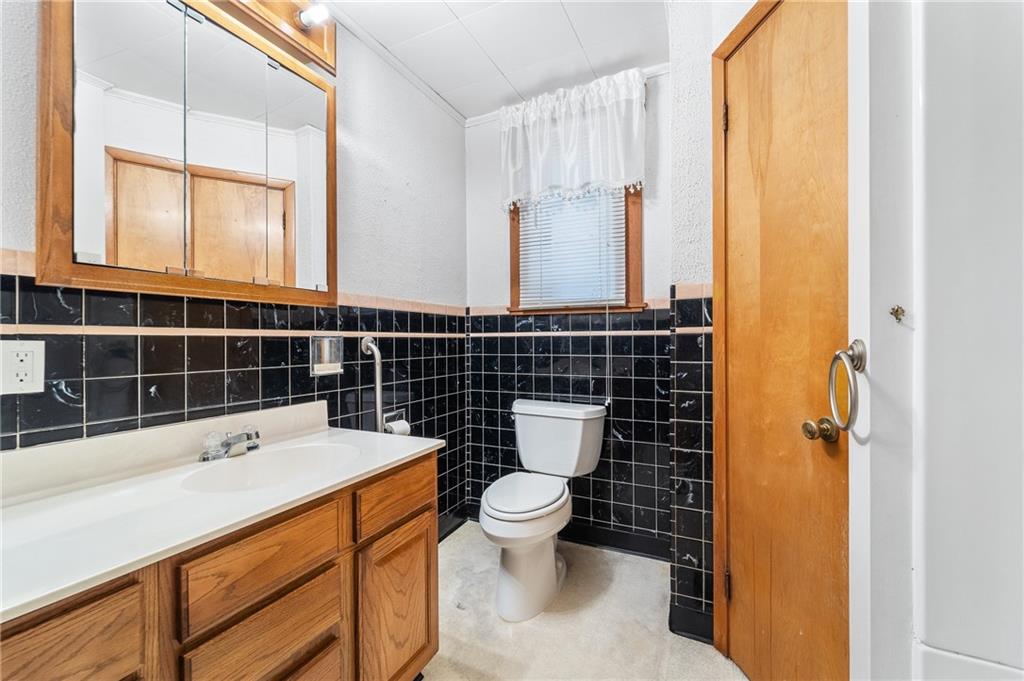 7 A Street Clarksville, PA 15322 - Photo 12 of 27 a bathroom with a sink a toilet and a mirror
