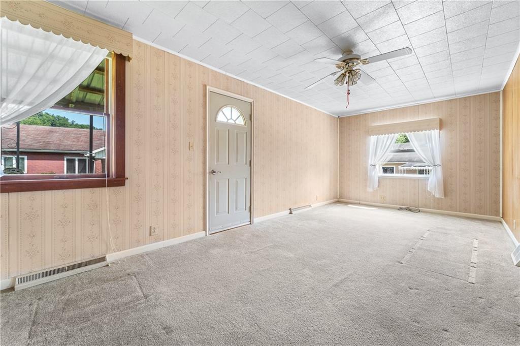 7 A Street Clarksville, PA 15322 - Photo 4 of 27 en empty room with windows and ceiling fan