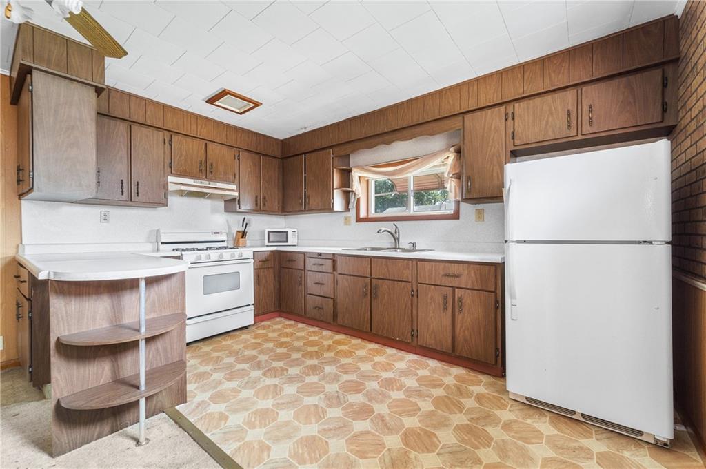7 A Street Clarksville, PA 15322 - Photo 8 of 27 a kitchen with a refrigerator sink and cabinets