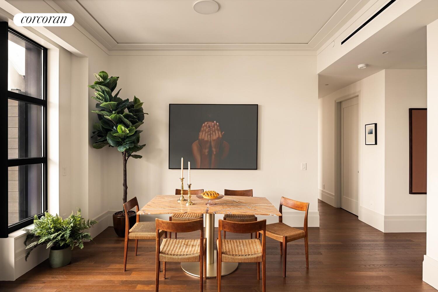 127 Kent Avenue, Unit 3K Brooklyn, NY 11249 - Photo 3 of 18 a view of a dining room with furniture window and wooden floor