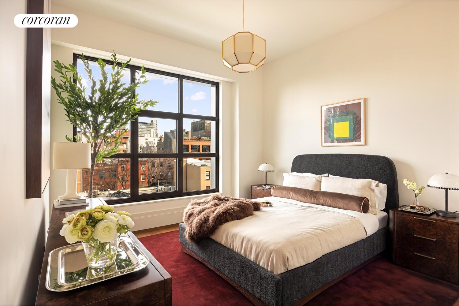 127 Kent Avenue, Unit 3K Brooklyn, NY 11249 - Photo 5 of 18 a bedroom with a bed and a large window