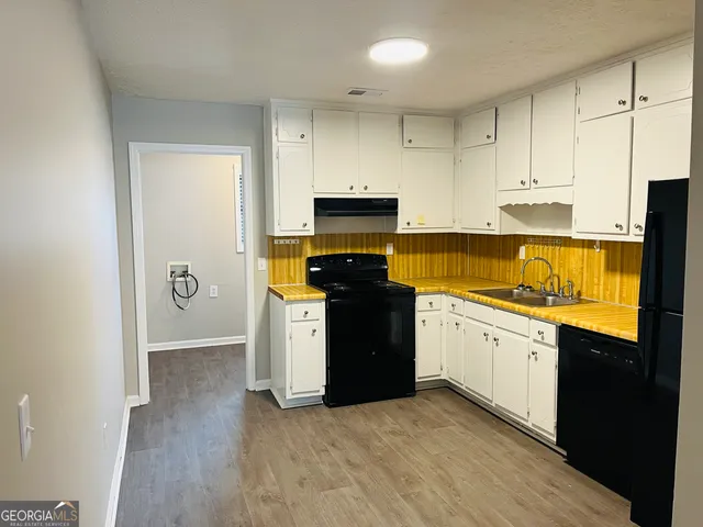a kitchen with a stove and a refrigerator