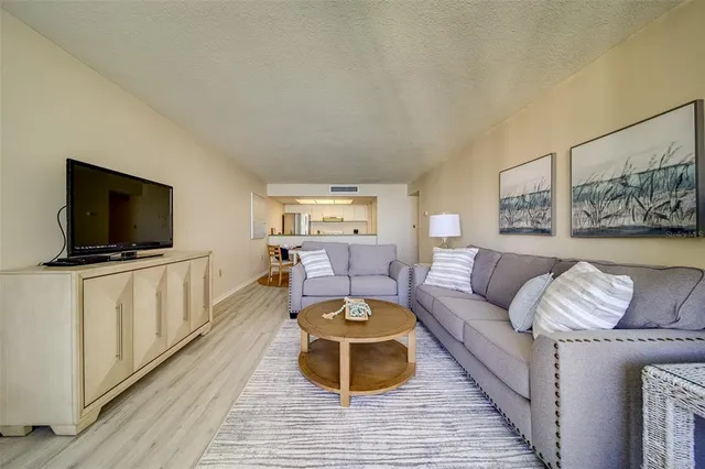 a bedroom with two beds and painting on the wall