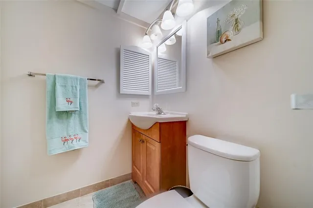 a bedroom with a bed lamp closet and window
