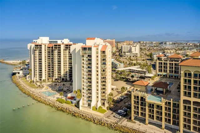 a view of a brick house with two chairs