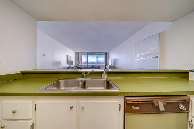 a kitchen with a refrigerator and cabinets