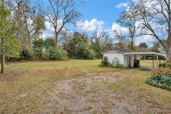 a front view of house with yard and trees