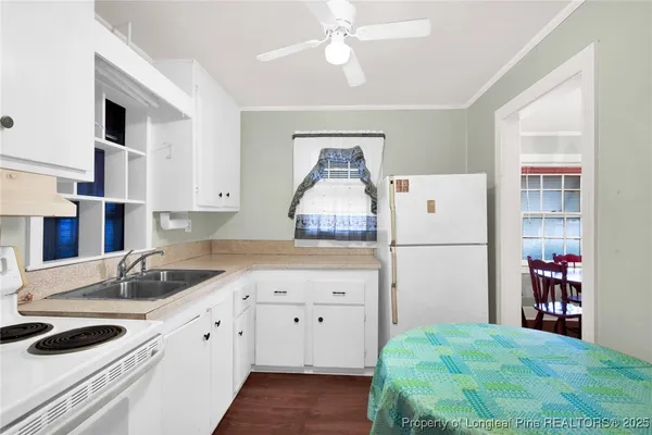 a kitchen with a sink a stove and cabinets