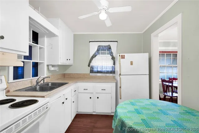 a kitchen with a sink a stove and cabinets