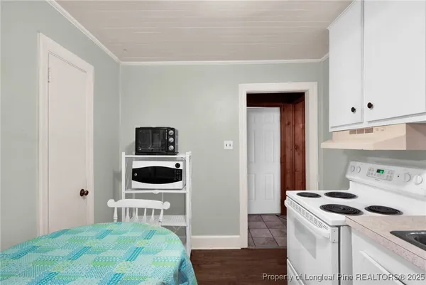 a bedroom with a stove and a bed
