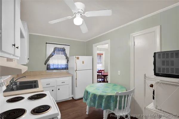 a kitchen with a sink a stove and a refrigerator