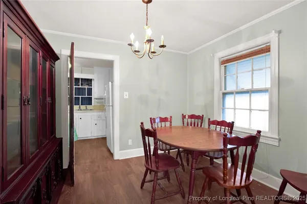 a view of a dining room with furniture and window