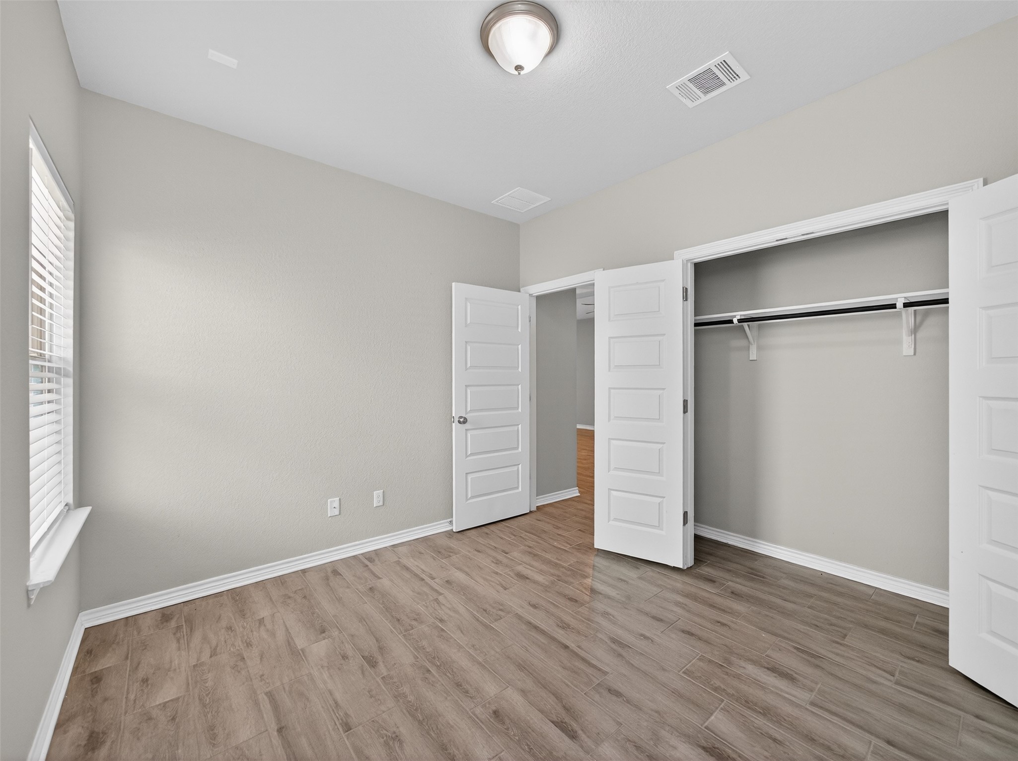 521 Rearing Mare Pass Georgetown, TX 78626 - Photo 19 of 39 an empty room with wooden floor and windows