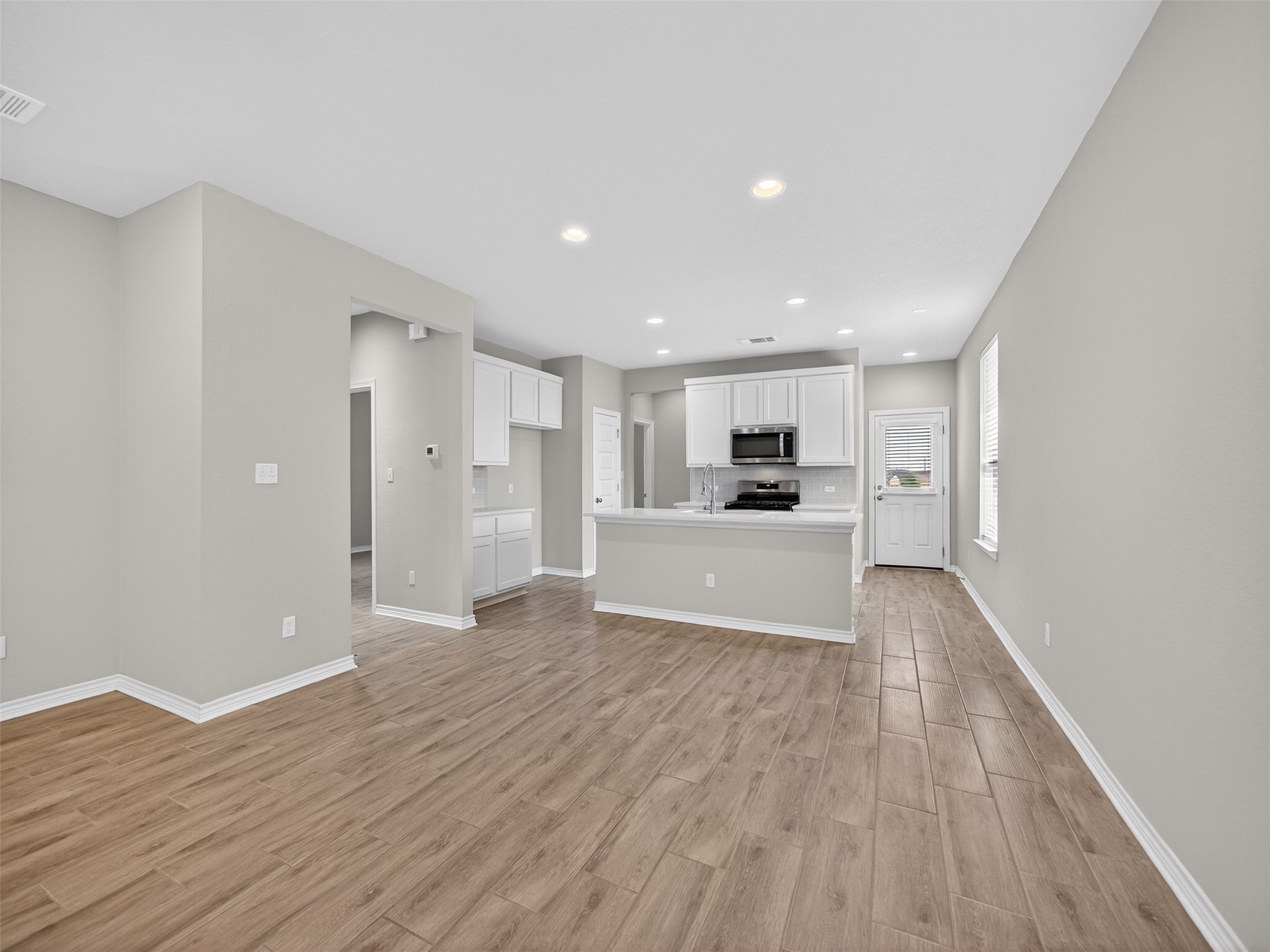 521 Rearing Mare Pass Georgetown, TX 78626 - Photo 6 of 39 a view of a kitchen with wooden floor and window