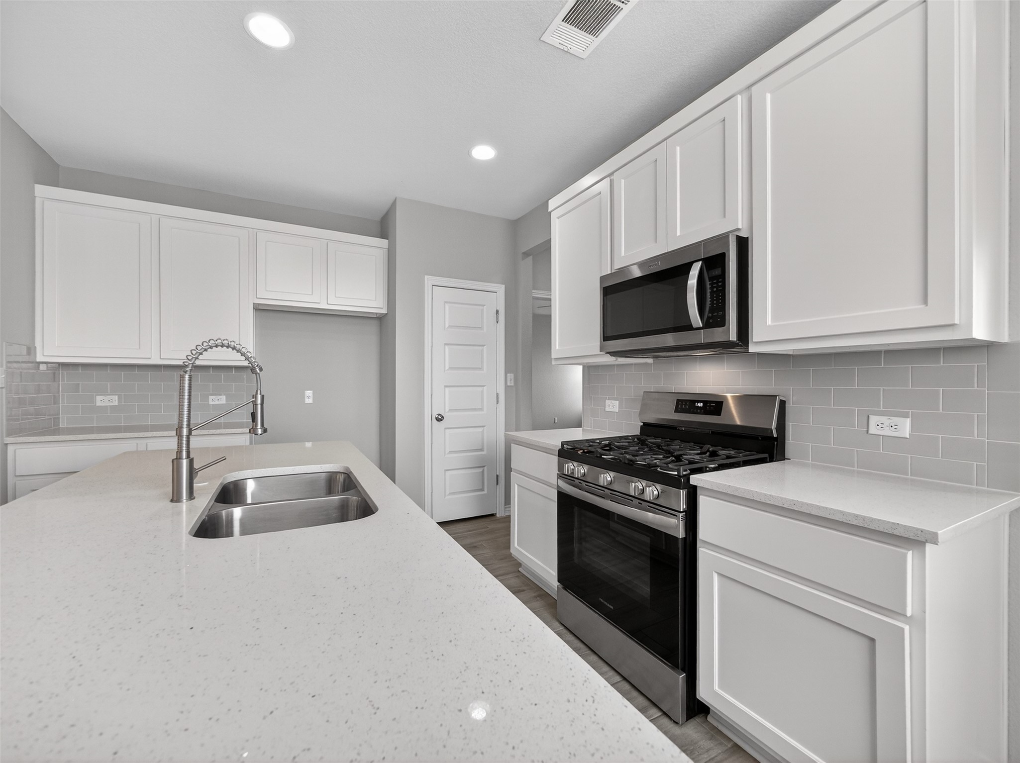 521 Rearing Mare Pass Georgetown, TX 78626 - Photo 9 of 39 a kitchen with granite countertop a sink a stove and cabinets