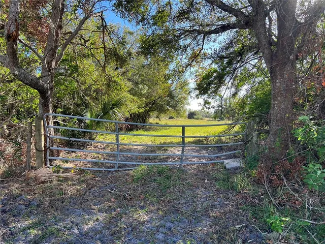 a view of a yard with swimming pool and sitting area