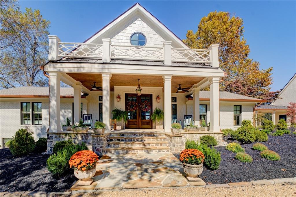 419 Parker Road McDonough, GA 30252 - Photo 3 of 103 a view of a white house with potted plants and a dining table