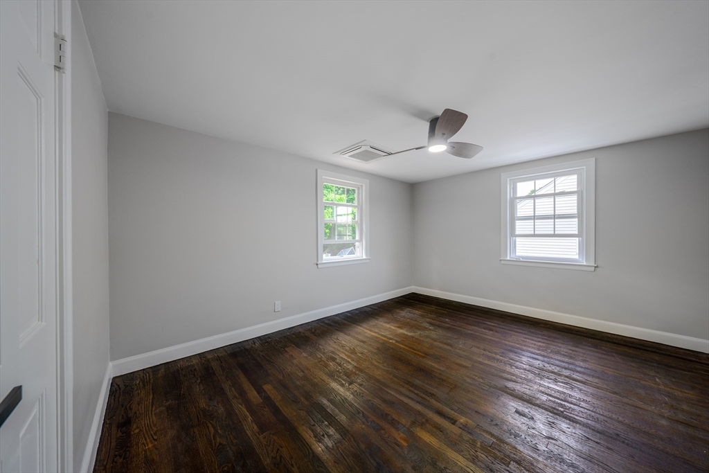 11 Clancy Road Boston, MA 02124 - Photo 18 of 19 a view of an empty room with wooden floor and a window