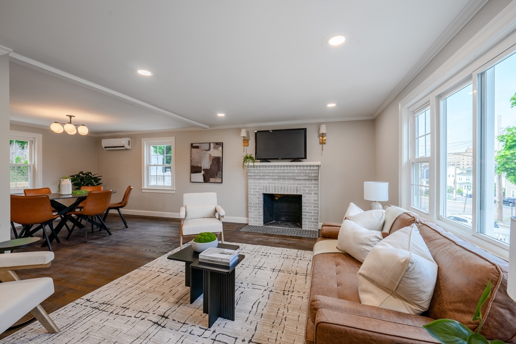 11 Clancy Road Boston, MA 02124 - Photo 4 of 19 a living room with furniture a fireplace and a large window