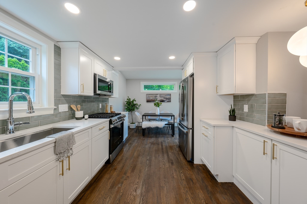 11 Clancy Road Boston, MA 02124 - Photo 8 of 19 a kitchen with white cabinets and appliances
