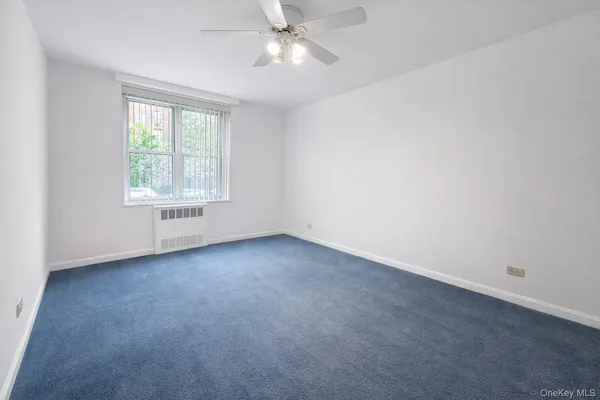 a view of an empty room with a ceiling fan