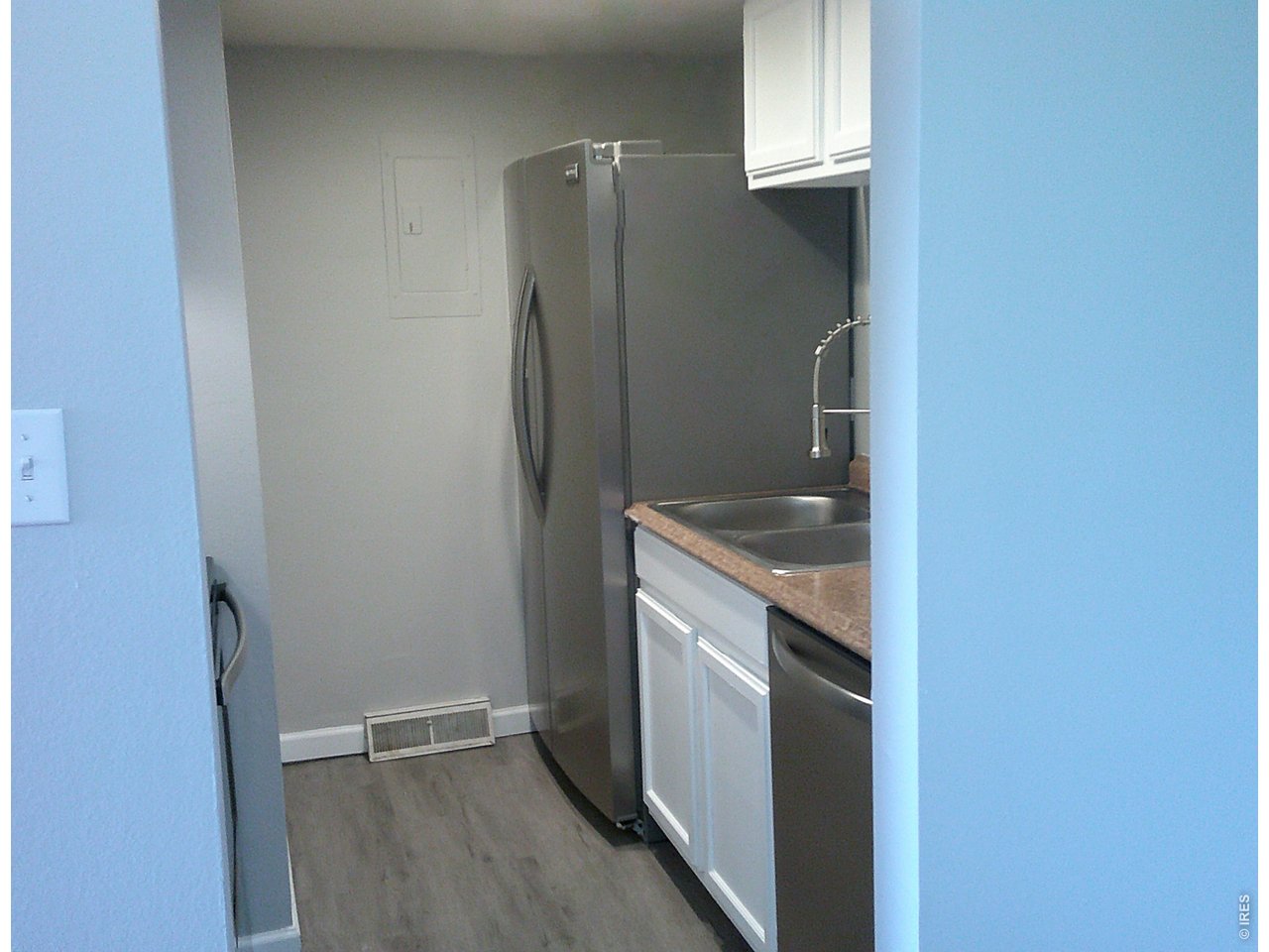 1165 South Oneida Street, Unit E Denver, CO 80224 - Photo 13 of 18 a kitchen with a refrigerator and cabinets