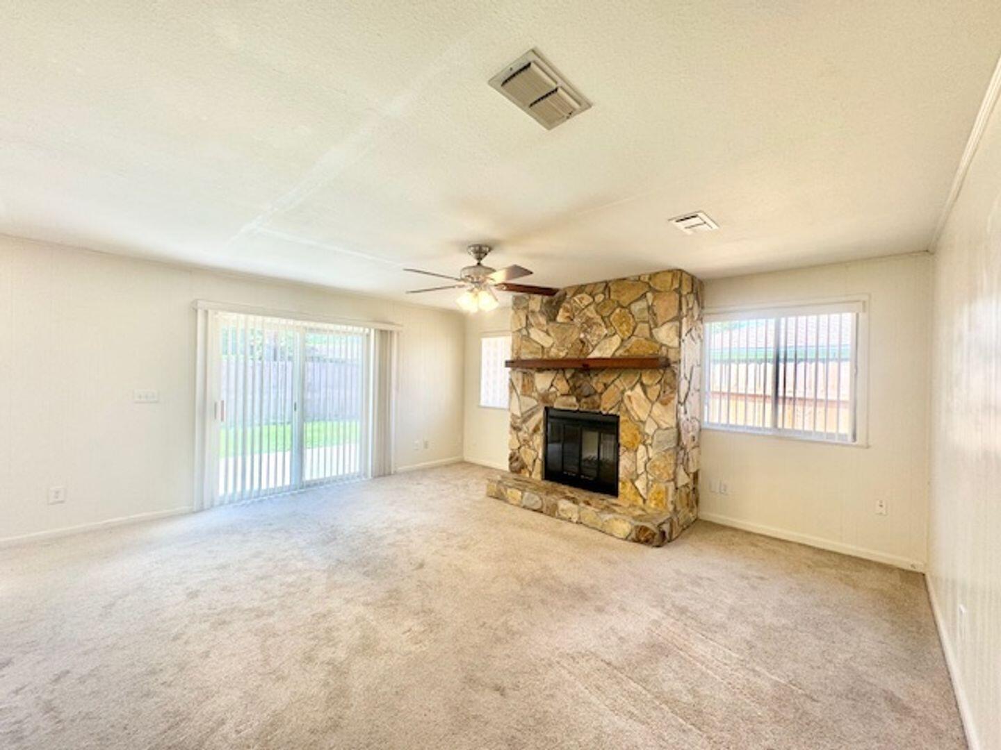 135 Perdido Circle Niceville, FL 32578 - Photo 15 of 22 an empty room with fireplace and windows
