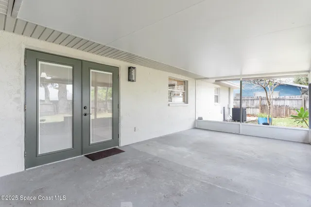 an aerial view of a house with garden space and a yard