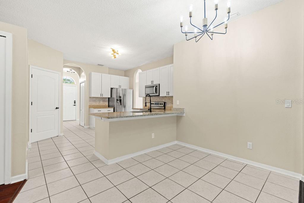 10641 Firebrick Court Trinity, FL 34655 - Photo 11 of 47 a kitchen with white cabinets and window