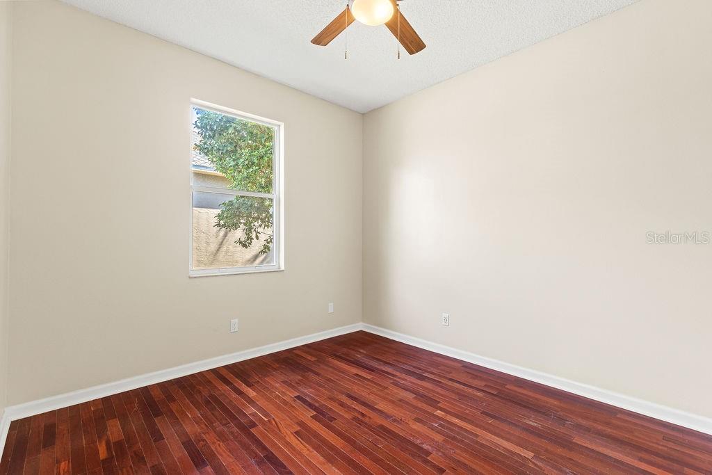 10641 Firebrick Court Trinity, FL 34655 - Photo 15 of 47 an empty room with a window and wooden floor