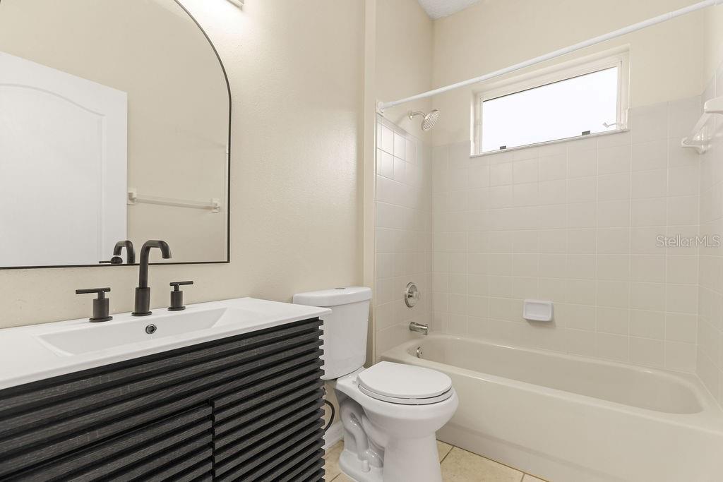 10641 Firebrick Court Trinity, FL 34655 - Photo 17 of 47 a bathroom with a sink a toilet and shower