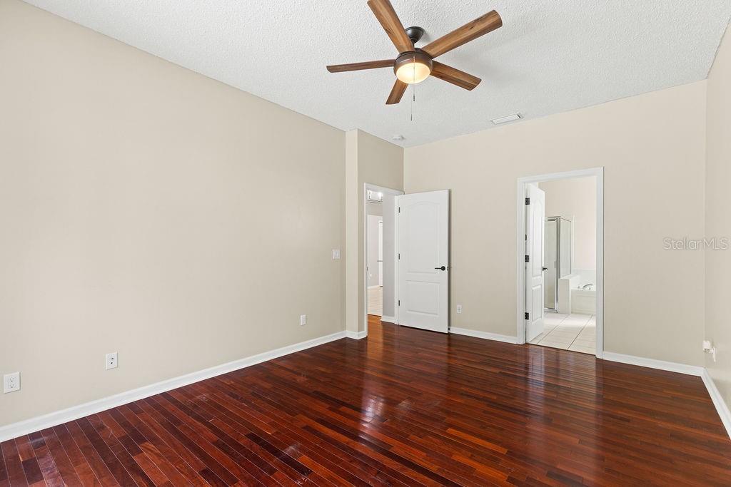 10641 Firebrick Court Trinity, FL 34655 - Photo 19 of 47 an empty room with wooden floor and windows