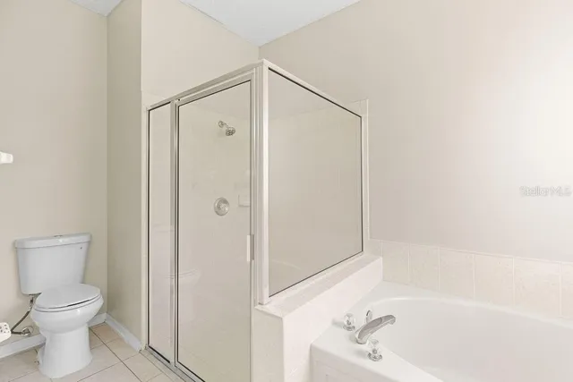 a bathroom with a bathtub a toilet and a shower