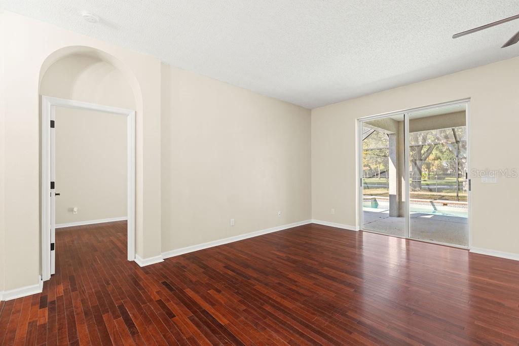 10641 Firebrick Court Trinity, FL 34655 - Photo 25 of 47 an empty room with wooden floor and windows