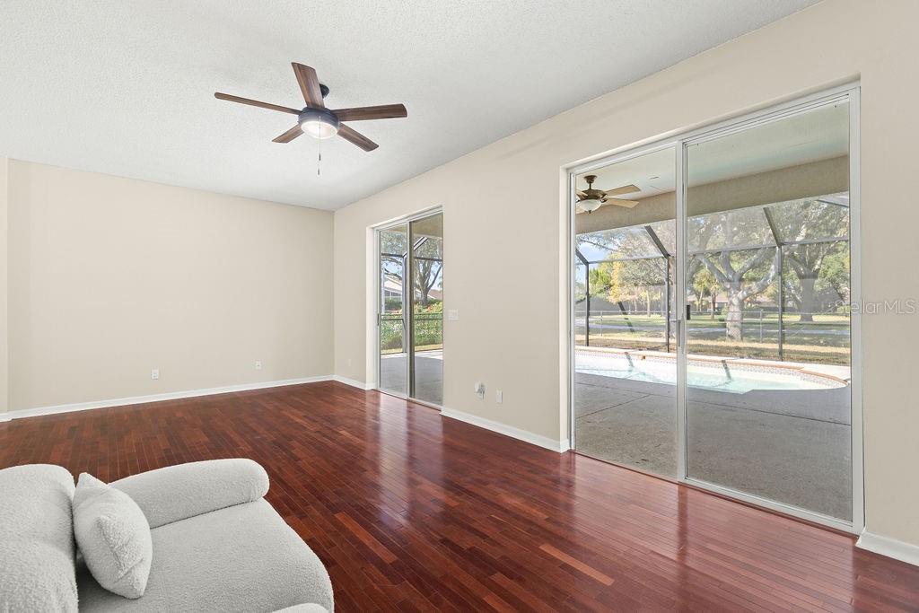 10641 Firebrick Court Trinity, FL 34655 - Photo 26 of 47 a view of workspace with wooden floor and windows