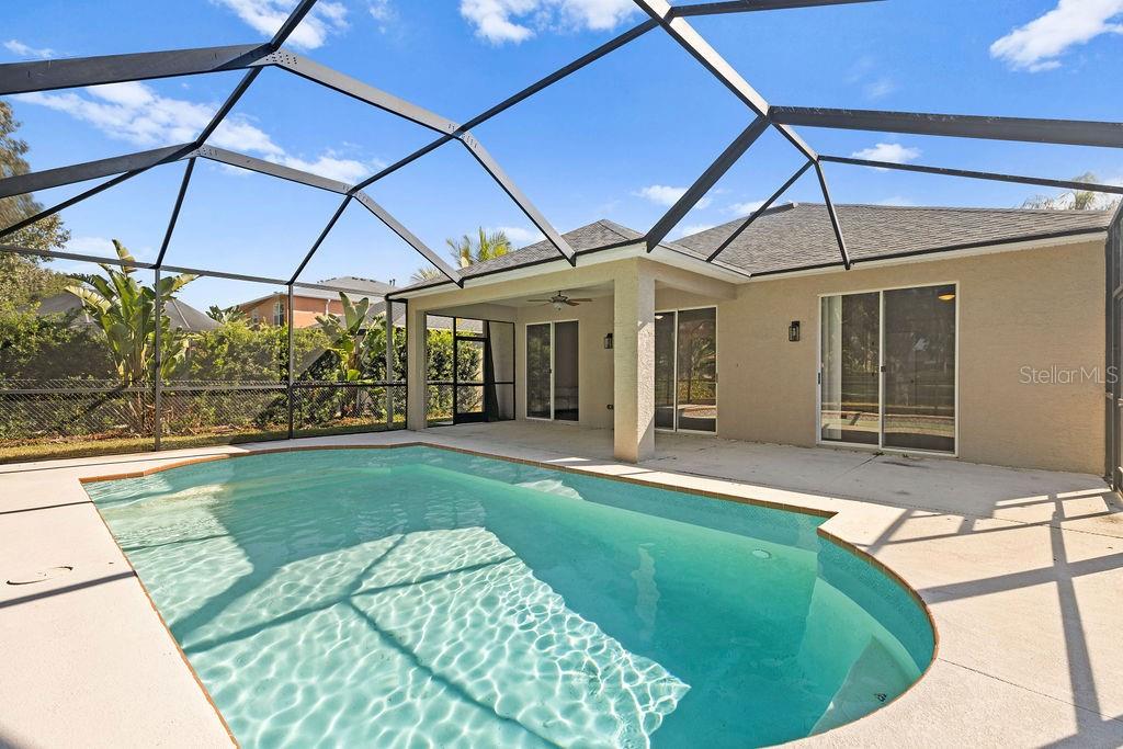 10641 Firebrick Court Trinity, FL 34655 - Photo 28 of 47 a view of a patio with a table and chairs under an umbrella