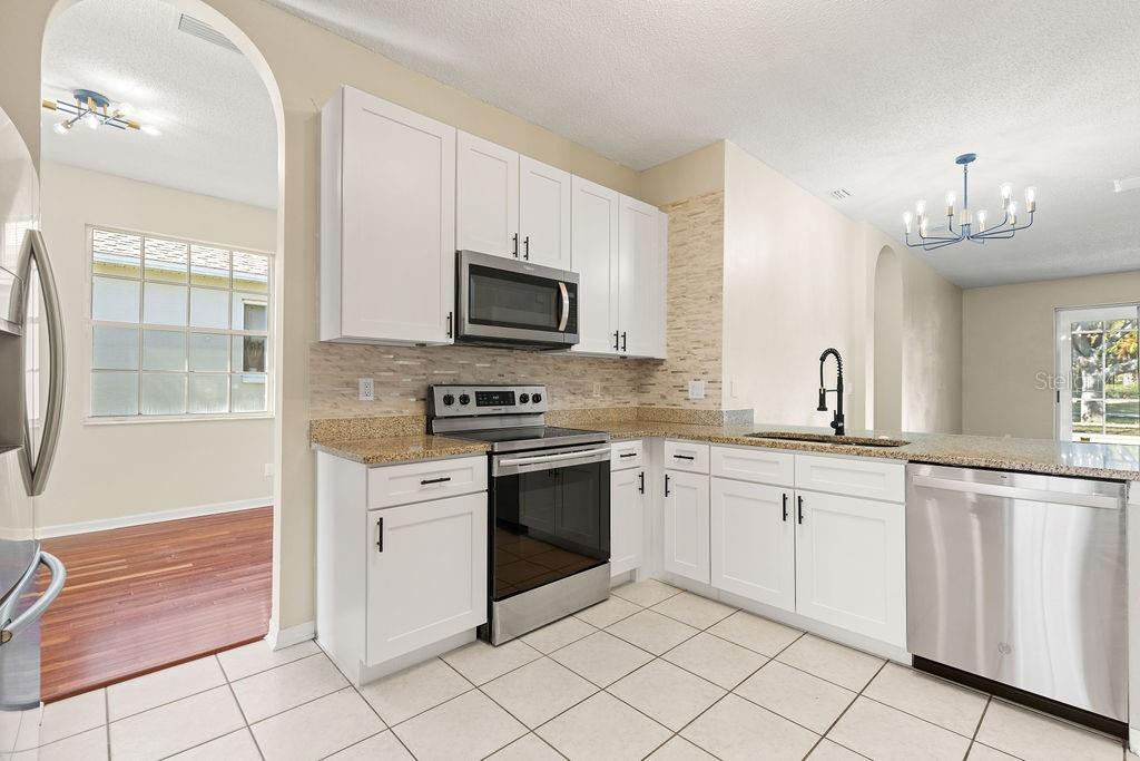 10641 Firebrick Court Trinity, FL 34655 - Photo 4 of 47 a kitchen with white cabinets appliances and a window