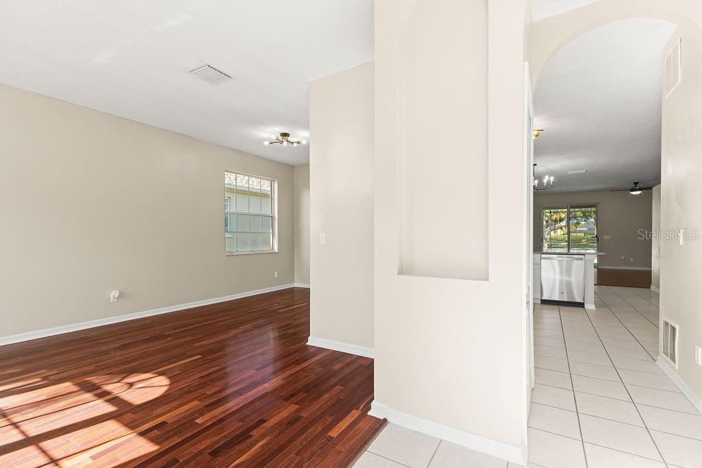 10641 Firebrick Court Trinity, FL 34655 - Photo 7 of 47 a view of a hallway with wooden floor and a bathroom