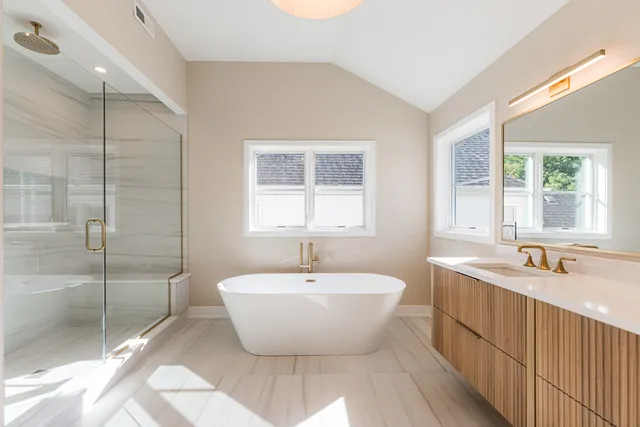 a spacious bathroom with a bathtub and 2 sink
