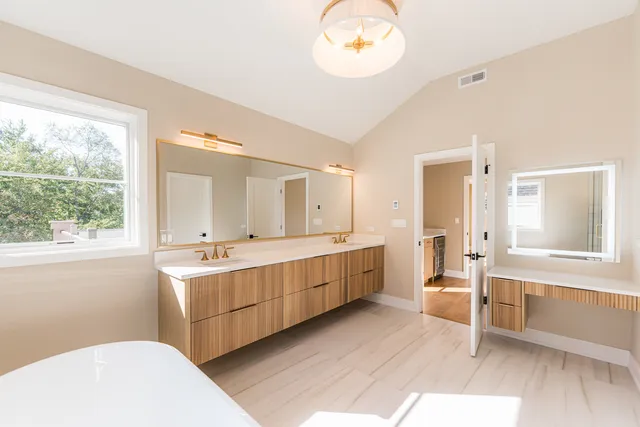 a large bathroom with a large tub and sink