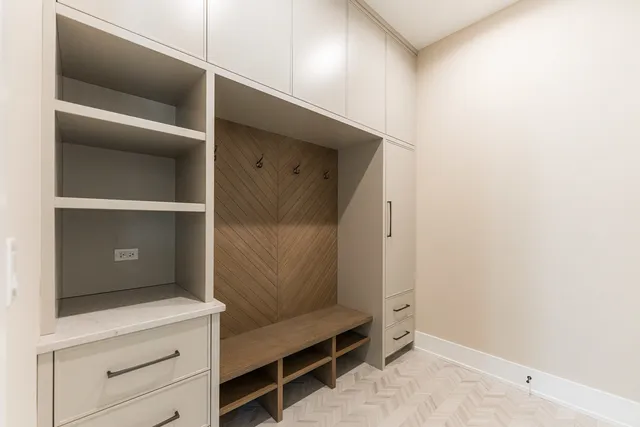 a room with a closet and wooden racks