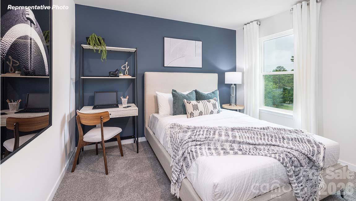 2150 10th Street Southeast Hickory, NC 28601 - Photo 14 of 30 a bedroom with a bed a table and chair