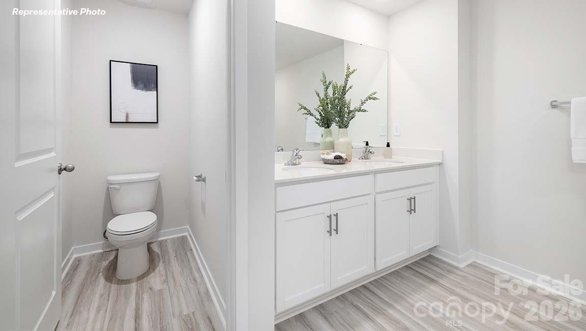 2150 10th Street Southeast Hickory, NC 28601 - Photo 16 of 30 a bathroom with a toilet a sink and mirror