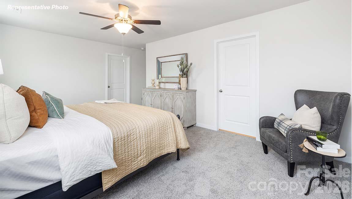2150 10th Street Southeast Hickory, NC 28601 - Photo 21 of 30 a bedroom with a bed and a chair