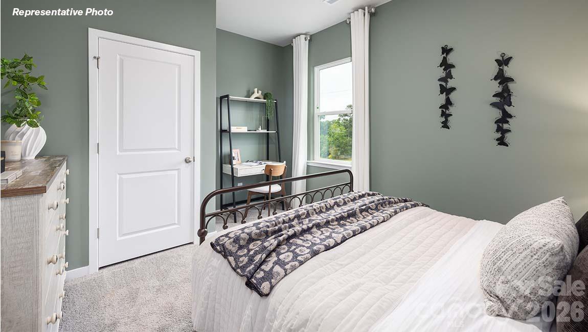 2150 10th Street Southeast Hickory, NC 28601 - Photo 25 of 30 a bedroom with a large bed and a potted plant