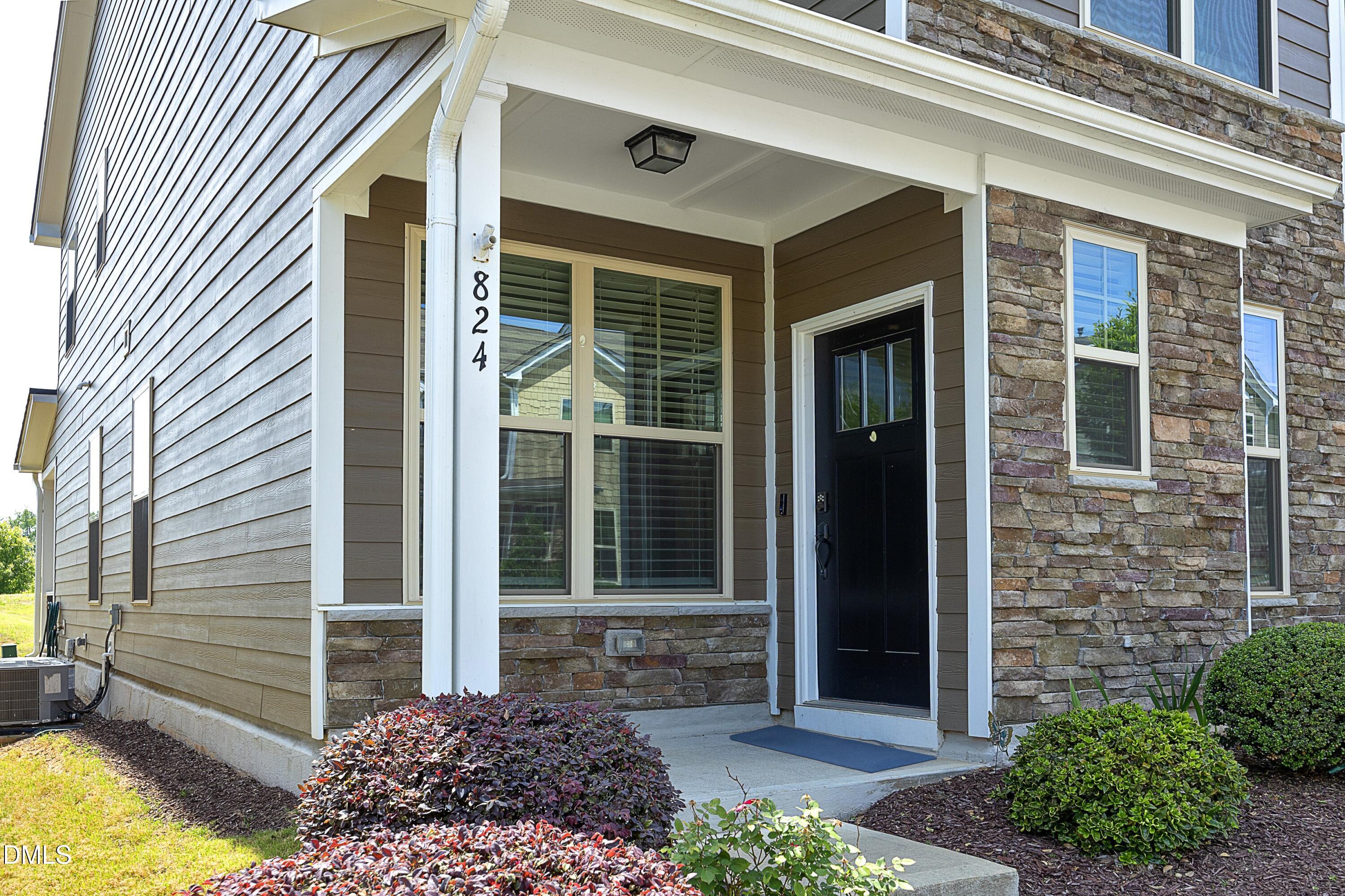 824 Country Downs Road Wake Forest, NC 27587 - Photo 2 of 41 a front view of a house with a yard