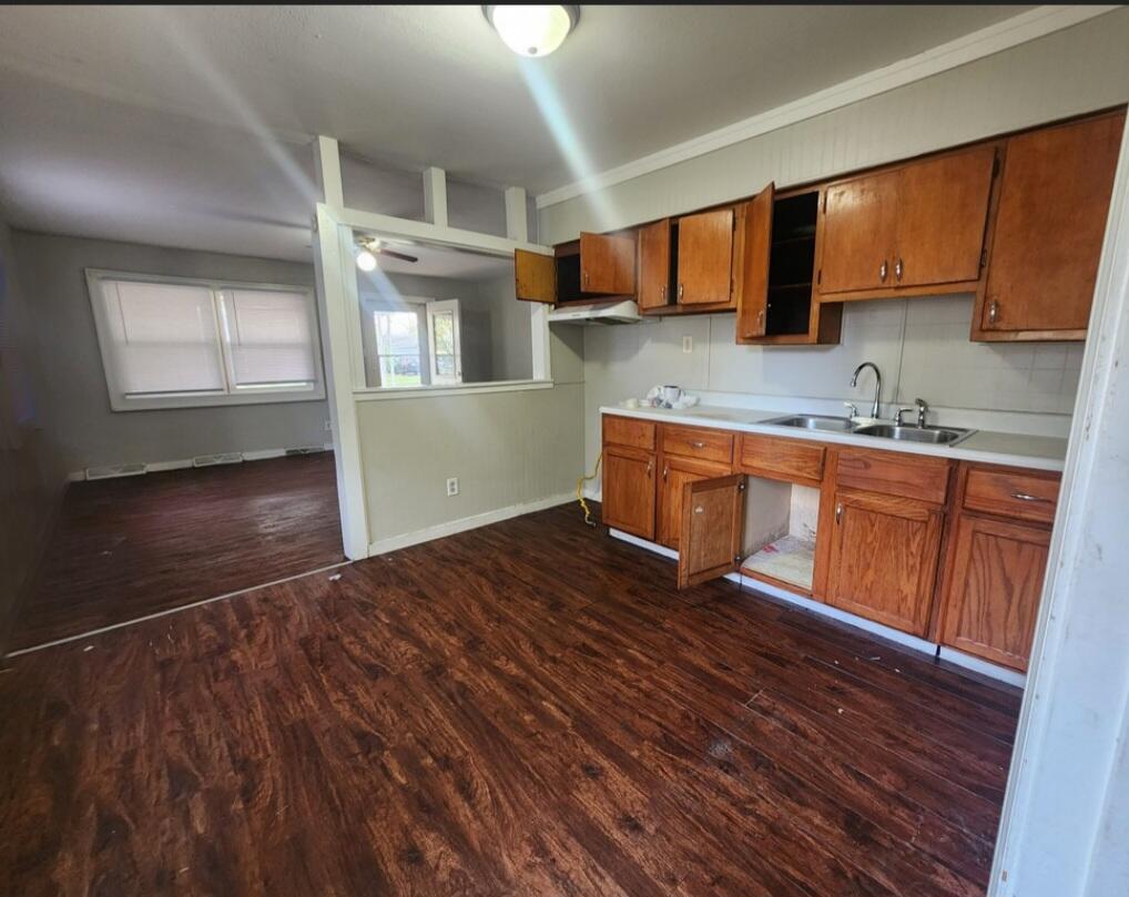 3515 164th Street Hammond, IN 46323 - Photo 3 of 12 a kitchen with wooden floors and wooden cabinets